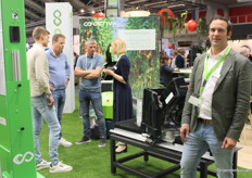 Tom Coen with Octiva was pleased to see that the robots brought along, including this robot arm from the Kompano robot which was being studied in the background by a delegation from Schenkeveld, were receiving plenty of attention.